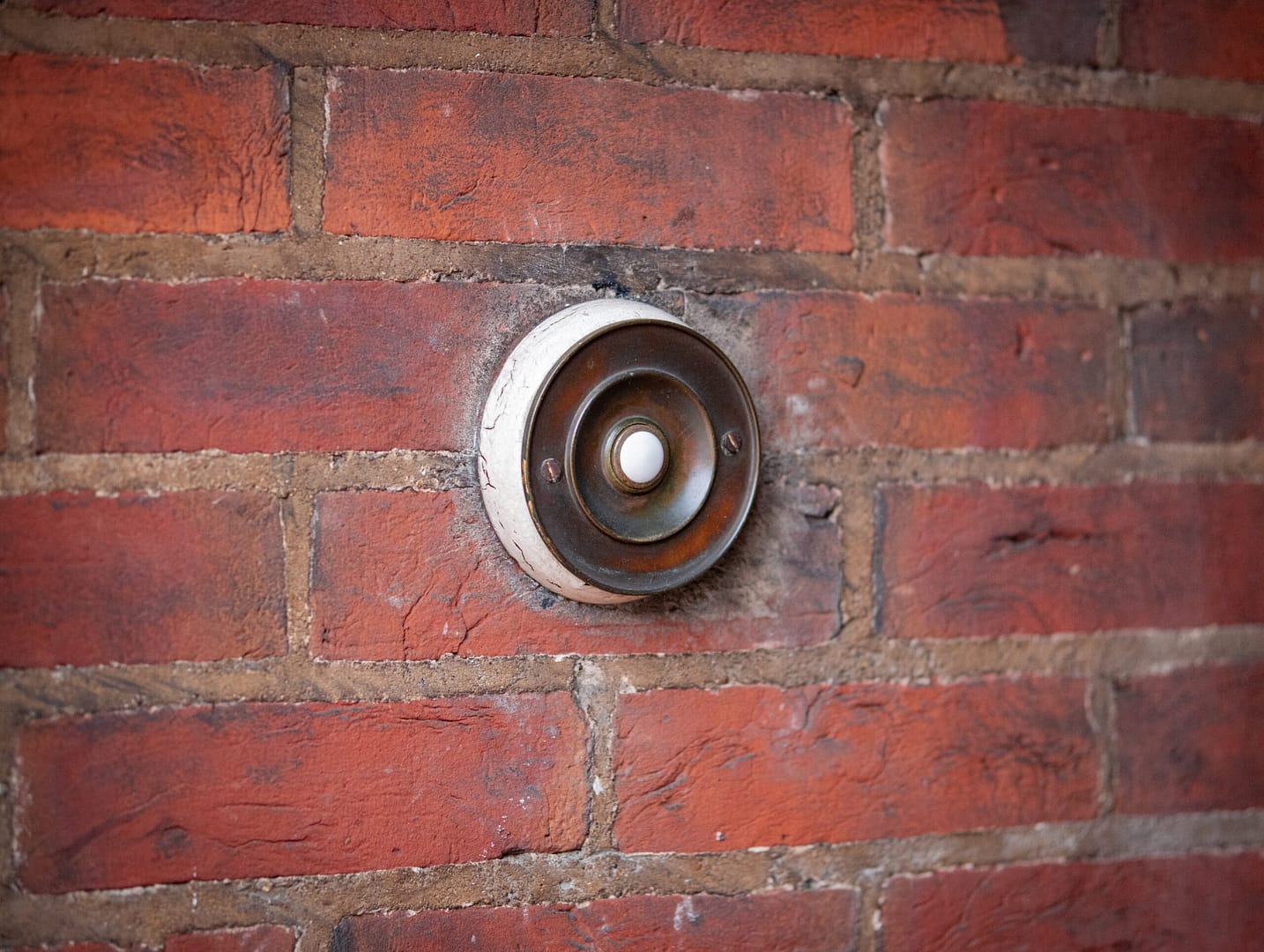brown and black round metal on brown brick wall